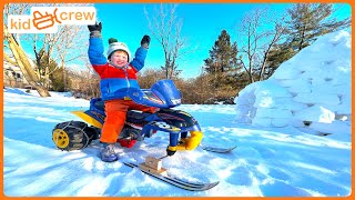 Driving Power Wheel snowmobile awesome winter sledding track and snow igloo Educational  Kid Crew [upl. by Ayahs]