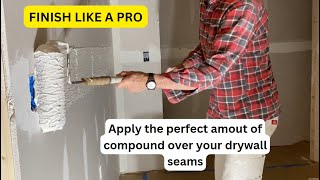 Using a paint roller to apply compound over drywall seams [upl. by Ainig]