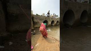 A woman catches fish from a large dam with a hook  amazing fishing in the canal  fishing shorts [upl. by Sunderland]