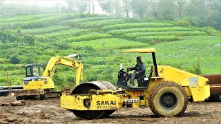 Mini Excavator Soil Compactor And Trucks Compacting Ground Using Rocks [upl. by Petta886]