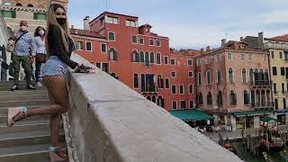 Granate styling walking in public evening near Rialto bridge VeniceItaly micro shorts wedges [upl. by Llerryt]