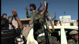 Libyan rebels fly flag in Zawiyah [upl. by Hgielak538]