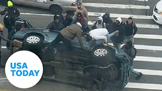 Good Samaritans New York City rush to help stuck driver flipped car  USA TODAY [upl. by Nonez]