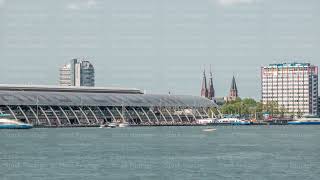 Close up view of Amsterdam Central Station with its curved roof and the Amstel River timelapse [upl. by Dorej]