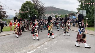 Massed Pipe Bands marching through Braemar to the 2022 Braemar gathering in Royal Deeside Scotland [upl. by Nnaeirb117]