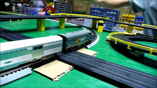 HO Slot Cars versus Passenger Train on our layout  Crashes at Road amp Rail crossing [upl. by Oneal942]