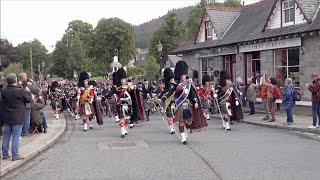 Massed Pipes and Drums start their march through Braemar to the 2022 Braemar Gathering in Scotland [upl. by Anat369]