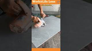 A skilled artisan cuts a precise hole in a floor tile with an angle grinder for pipe installation [upl. by Christiane659]