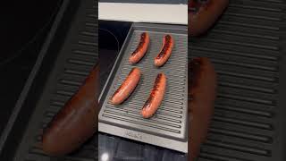 Grilling sausages in our Poggenpohl kitchen with the Miele induction cooktop and grille pan [upl. by Ecirtaed]