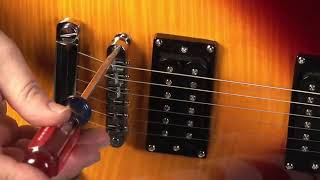 How to Adjust the Bridge on an Electric Guitar [upl. by Rohpotsirhc888]