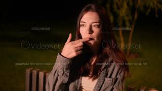 Closeup view of woman dipping french fries in ketchup sauce and eating them [upl. by Ittam232]