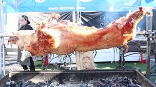 Whole hog roasting on a barbecue spit offers a unique culinary experience that celebrates culture [upl. by Ardnahc549]