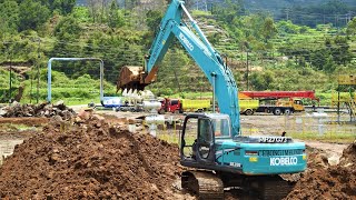 Kobelco SK200 Excavators Moving Rocks And Dirt On The Geothermal Well Pad Site [upl. by Anaihr]