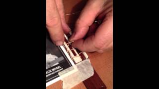 Stringing up a 12 hole bridge on spanish guitar [upl. by Dralliw]