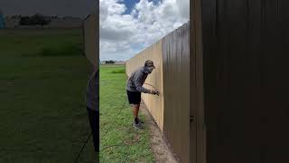 Spraying and Backbrushing Fence Stain painting fence construction [upl. by Amleht]