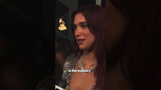 Dua Lipa sparkles on the Grammys 2024 red carpet in a lowcut silver gown shorts [upl. by Devol934]