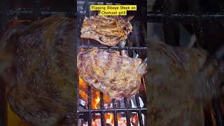 Flipping Ribeye Steak on a Charcoal Grill flipping ribeyesteak grilling shortsfeed shorts [upl. by Enibas]