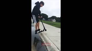 Kid falls off scooter jumping curb in slo mo [upl. by Dinesh942]