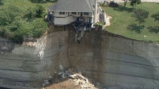 Couple looks on as house falls off cliff [upl. by Dewain663]