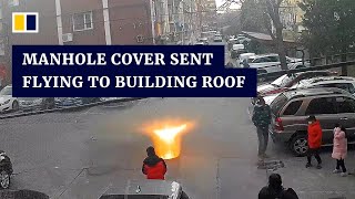 Manhole cover sent flying to building roof after boy sets off firecracker [upl. by Millman22]