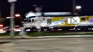 BrightLine train high speed rail in Florida USA At speed across a road crossing [upl. by Asteria]