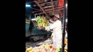 Fruit vendor protecting his grapes from train passengers in Bangladesh fruittrading fruitpickers [upl. by Muraida56]