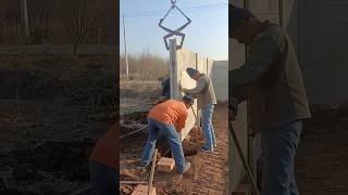 Process of excavator installing cement post for building wall [upl. by Esertal]