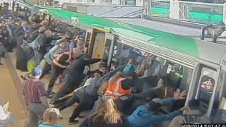 Mind the gap Commuters push train to save trapped man in Perth [upl. by Cherie]