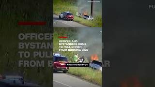 Officer and bystanders rush to pull driver from burning car [upl. by Anaeli]