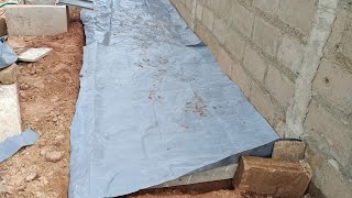 Installing damp proof membrane before pouring concrete slab for shed — Building in Ghana [upl. by Carper]