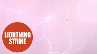 SWNS Video  A bolt of lightning struck a plane on its descent into Heathrow airport last night [upl. by Sabba]