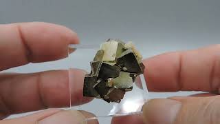 Pyrite with pink fluorescent calcite from Kosovo – thumbnail [upl. by Herrle496]