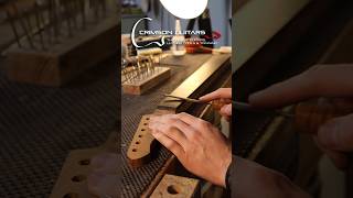 Installing guitar frets a very repetitive but satisfying process in Guitar Building luthier [upl. by Gall338]