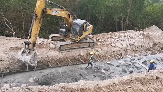 Excavator at work on a hillside construction site [upl. by Neeruam]