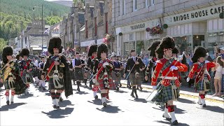 Drum Majors lead the combined Pipe Bands over river Dee marching to 2022 Ballater Highland Games [upl. by Anitsej]