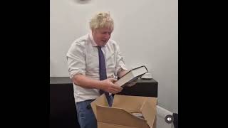 Boris Johnson opens a box full of copies of his book [upl. by Arej]