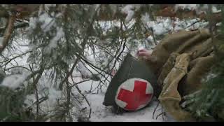 Reenactor Dressed As USA Soldier Medic In Winter Season Army Of World War II Corpsman Helmet Lies [upl. by Bannerman]