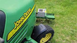 John Deere x485 with a 54inch front mount detacher raking up the dead stuff [upl. by Ateuqahs605]