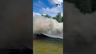 Boater propels water at burning speedboat to help out out fire [upl. by Lacy]