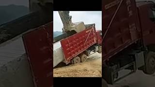 The process of loading a stone block onto a truck body using an excavator [upl. by Dias]