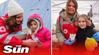 Ukrainian refugee children met with food and toys from the Red Cross as they travel to safety [upl. by Alyahsal]