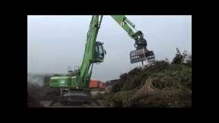 SENNEBOGEN  Recycling Material Handler 825 feeding shredder loading compost [upl. by Enamrej]