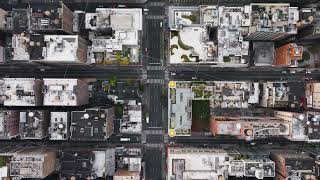 Aerial views showcase a yellow cab maneuvering through a busy New York City intersection [upl. by Ahsenak840]