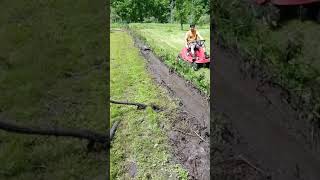 Cleaning ditches homemade ditch tool towed by lawnmower [upl. by Trembly]