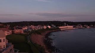 Aerial sunset coastline view of Ogunquit Maine USA drone revealing waterfront homes and resorts [upl. by Nitaf193]