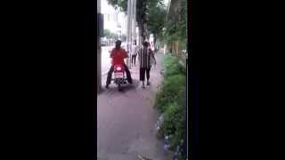 Woman riding motorbike on the pavementsidewalk past other pedestrians [upl. by Audsley]