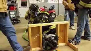 Firefighter with SCBA crawls through wall training prop [upl. by Silvio]