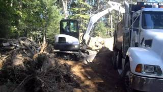 MiniExcavator Loading Stumps in to Kenworth TriAxle [upl. by Llemej]