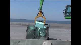 SENNEBOGEN  Material Handling 850 Mobile Material Handler loading waste bales from ship to truck [upl. by Yanetruoc]